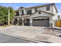 Attractive two-story home showcasing a three-car garage and desert landscaping under a clear sky at 11521 E Quintana Ave, Mesa, AZ 85212