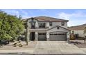 Charming two-story home featuring a spacious three-car garage, desert landscaping, and a beautiful tiled roof at 11521 E Quintana Ave, Mesa, AZ 85212