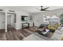 Bright living room with hardwood floors, ceiling fan, and a comfortable seating arrangement at 1321 W 14Th St, Tempe, AZ 85281