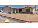 Traditional-style home with a two-car garage, neutral paint, and a low brick wall at 136 E San Angelo Ave, Gilbert, AZ 85234