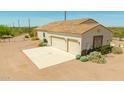 Spacious three-car garage featuring two doors and exterior stone accents, complemented by desert landscaping at 1623 E Hidalgo St, Apache Junction, AZ 85119