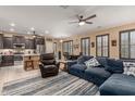Open-concept living room features a large sectional sofa and seamless flow into the modern, eat-in kitchen at 16259 W Papago St, Goodyear, AZ 85338