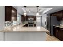 Modern kitchen featuring stainless steel appliances, sleek countertops, and stylish backsplash at 2233 W Oraibi Dr, Phoenix, AZ 85027