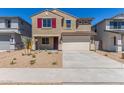 Two-story home with a two-car garage, a well kept yard, and concrete driveway at 22863 N 183Rd Dr, Surprise, AZ 85387