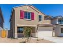 Two-story home with a two-car garage, an inviting front entrance and red shutters at 22863 N 183Rd Dr, Surprise, AZ 85387