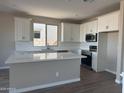 Modern kitchen featuring an island, white cabinets, stainless steel appliances, and subway tile backsplash at 22863 N 183Rd Dr, Surprise, AZ 85387