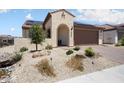 Charming single-story home featuring desert landscaping, a stucco facade, and a tile roof with solar panels at 26824 W Ponderosa Ln, Buckeye, AZ 85396