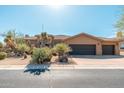Beautiful desert-landscaped home with a three car garage and attractive front entryway at 28768 N 95Th Way, Scottsdale, AZ 85262
