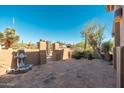 A private outdoor patio with a tile floor, water feature, and mature landscaping at 28768 N 95Th Way, Scottsdale, AZ 85262