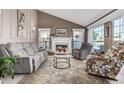 Cozy living room with vaulted ceilings, fireplace, and large windows providing ample natural light at 3054 E Norwood St, Mesa, AZ 85213
