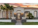 Inviting front entrance with stone accents, manicured landscaping and a modern glass front door at 3354 E Jaeger Cir, Mesa, AZ 85213