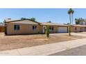 Single-story home with brick facade, attached garage, and a tidy front yard in a well-established neighborhood at 3539 W Davidson Ln, Phoenix, AZ 85051