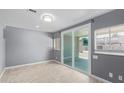 Modern living room with tile floors, sliding glass doors, and neutral paint for a versatile design at 3539 W Davidson Ln, Phoenix, AZ 85051