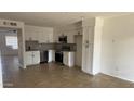 Open-concept kitchen with white cabinets, stainless steel appliances, and ample countertop space at 4217 W Medlock Dr, Phoenix, AZ 85019