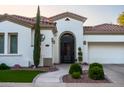 Close-up of the front entrance with a decorative wrought iron door and manicured landscaping at 4636 E Carriage Ct, Gilbert, AZ 85297