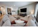 Spacious living room featuring a large sectional sofa, mounted TV, and modern decor at 4636 E Carriage Ct, Gilbert, AZ 85297