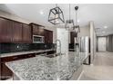 Modern kitchen with granite countertops, stainless steel appliances and island at 4654 W Suncup Dr, San Tan Valley, AZ 85144