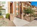 Multi-level building exterior featuring stone accents, desert landscaping, and a welcoming entrance area at 4909 N Woodmere Fairway -- # 1004, Scottsdale, AZ 85251