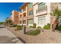 Beautiful condominium exterior with balconies, desert landscaping, and manicured shrubs at 4909 N Woodmere Fairway -- # 1004, Scottsdale, AZ 85251