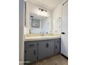 Bathroom featuring a gray vanity with a white countertop and a mirrored wall at 530 S Alma School Rd # 75, Mesa, AZ 85210