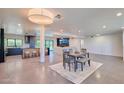 Open concept living room with modern kitchen, dining area, and natural light at 5324 E Hillery Dr, Scottsdale, AZ 85254