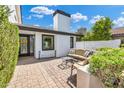 Cozy outdoor patio with comfortable seating, privacy landscaping and brick pavers, perfect for relaxation at 5435 E Cambridge Ave, Phoenix, AZ 85008