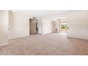 Bright living room with neutral carpet, access to a balcony, and multiple doorways for easy movement throughout the house at 839 Leisure World --, Mesa, AZ 85206