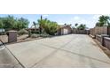 Spacious driveway leading to the garage with ample parking and desert landscape at 18212 N 43Rd Pl, Phoenix, AZ 85032