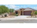 Attractive single-story home featuring a well-manicured yard and a two-car garage at 18333 N Presley Ln, Maricopa, AZ 85138