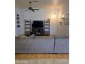 Living room with a large sectional sofa, wood flooring, and entertainment center at 2125 E Danbury Rd, Phoenix, AZ 85022