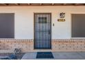 Close-up of the front door with a decorative security screen, house number and a 'welcome' mat at 215 S 132Nd St, Chandler, AZ 85225