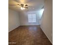 A bright living room boasts tile floors, a ceiling fan, and natural light, perfect for relaxation at 2367 E Huntington Dr, Phoenix, AZ 85040