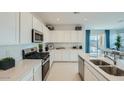 Modern kitchen with stainless steel appliances and white cabinetry at 24962 N 174Th Ave, Surprise, AZ 85387
