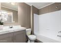 Clean bathroom featuring a shower-tub combo, gray vanity, and modern fixtures at 320 E Mckellips Rd # 45, Mesa, AZ 85201