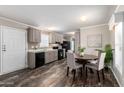 Open kitchen and dining area featuring black appliances, gray cabinets, and a dining table at 320 E Mckellips Rd # 45, Mesa, AZ 85201