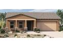 Charming single-story home features a cozy front porch, two-car garage, and low-maintenance desert landscaping at 32978 N 132Nd Ln, Peoria, AZ 85383