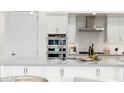 Stylish kitchen with stainless steel appliances, herringbone backsplash, and pendant lighting over the island at 5250 E Deer Valley Dr # 140, Phoenix, AZ 85054