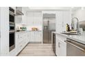 Bright, modern kitchen features stainless steel appliances, white cabinets, and a sleek countertop at 5250 E Deer Valley Dr # 140, Phoenix, AZ 85054