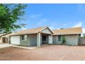 Inviting single-story home with a charming entrance and low-maintenance desert landscaping at 5533 W Sunnyside Dr, Glendale, AZ 85304