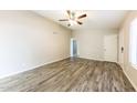 Bright living room with ceiling fan and stylish wood-look flooring at 5533 W Sunnyside Dr, Glendale, AZ 85304
