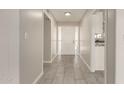 Bright hallway with updated tile flooring and neutral paint, leading to the main living areas at 6022 E Colby St, Mesa, AZ 85205
