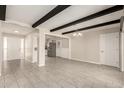 Spacious living room with beam ceilings, open floor plan, tile floors, and ample natural light at 6022 E Colby St, Mesa, AZ 85205