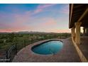 Enjoy stunning sunset views from the lovely pool and brick patio at 6349 E Hummingbird Ln, Paradise Valley, AZ 85253