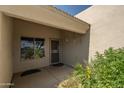 Inviting front porch area with decorative plants and a secure screen door entrance at 64 N 63Rd N St # 33, Mesa, AZ 85205