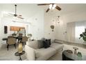 Open-concept living room with neutral decor, dining area, and light wood floors at 64 N 63Rd N St # 33, Mesa, AZ 85205