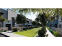 Inviting street view with modern townhomes, manicured lawns, and mature trees for a serene setting at 733 E Commonwealth Ave # 36, Chandler, AZ 85225