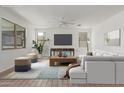 Spacious living room featuring a large television, wood floors and modern décor at 7413 S 32Nd Dr, Phoenix, AZ 85041