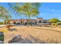 Stunning home displaying desert landscaping, rock features, and a circular tower at 8024 E Lone Mountain Rd, Scottsdale, AZ 85266