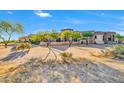 Gorgeous home boasting desert landscaping, a stone facade, and a circular tower at 8024 E Lone Mountain Rd, Scottsdale, AZ 85266