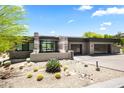 Contemporary home with a desert landscape, grey exterior, two-car garage, and modern architecture at 10641 E Blue Sky Dr, Scottsdale, AZ 85262